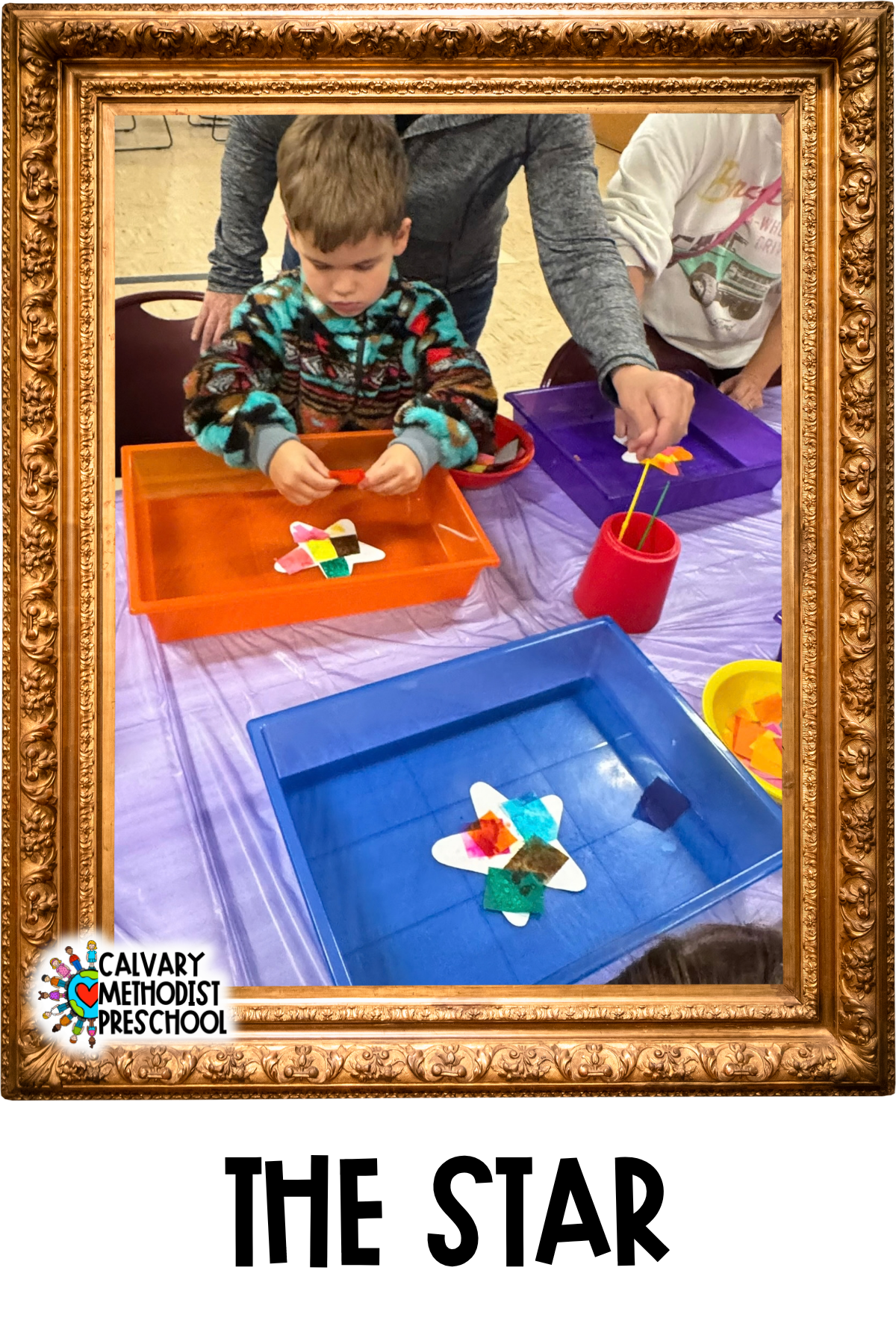 Image of a young boy covering a star cut out with bleeding tissue paper.